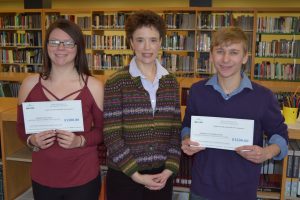 (Center) Shelly Clark, Vice President of Operations, Maine Real Estate & Development Association, presents NMCC students Jordyn Doucette and Robert Courtemanche with $1,500 scholarships from MEREDA.