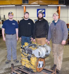 NMCC Diesel Hydraulic students Zachary Morton, Mason Molloy, Dylan Griffin and Caleb Castonguay with the Caterpillar C3.3B Tier 4 Emissions Engine.