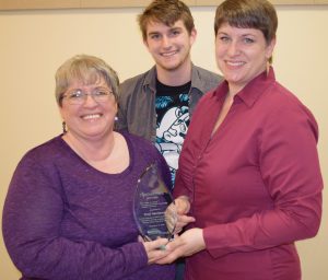 Tomi Henderson of Mars Hill was presented with the Torchbearer Award by the NMCC  Alumni & Friends Organization during its annual reception.  Pictured from  left: Tomi Henderson, grandson Jonathan Henderson and  daughter Tara Henderson who was elected the Organization’s  president during the annual meeting. 